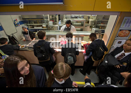 Pupils from Loreto High School in Chorlton, south Manchester, lining up to be served a school dinner by top chef Sukhdev Singh. Stock Photo