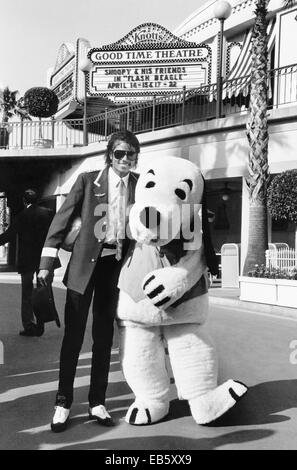 Singer Michael Jackson stands with costumed character Snoopy at Knott's Berry Farm amusement park April 14, 1984 in Buena Park, California. Stock Photo