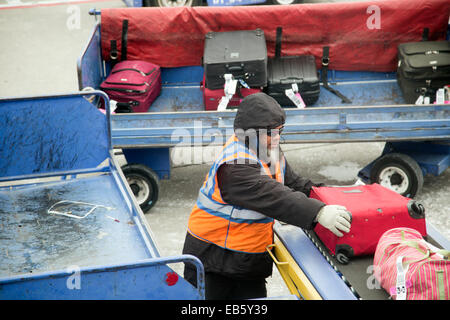 Denver, Colorado - A baggage handler unloads luggage from a Southwest Airlines plane at Denver International Airport. Stock Photo