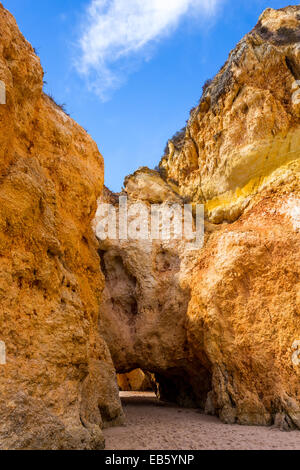 Hole of a big cave in the stones of the beach, Algarve Portugal Stock Photo