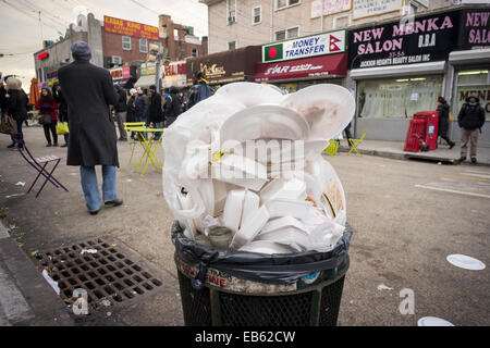 An overflowing trash can, filled mostly with styrofoam packaging,  is seen in Diversity Plaza in Jackson Heights, New York Stock Photo