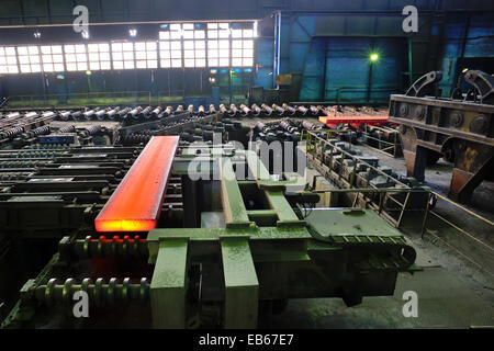 hot steel plate on conveyor inside of steel plant Stock Photo