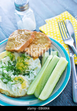 fried eggs and toasts on the plate Stock Photo