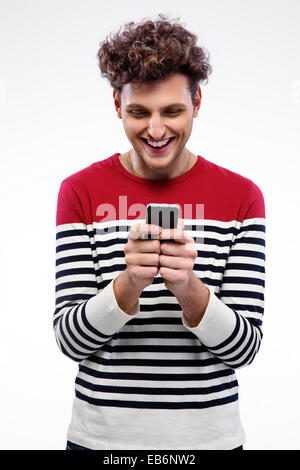 Smiling man using smartphone over gray background Stock Photo