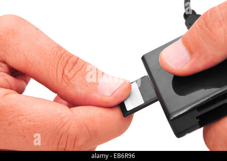 someone inserting a memory card into a memory card reader Stock Photo