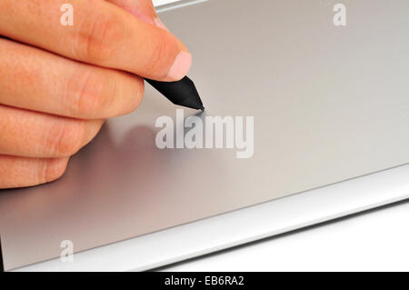 someone using a stylus in a graphics tablet Stock Photo