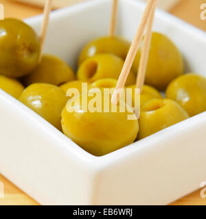 a bowl with olives with toothpicks served as tapas Stock Photo