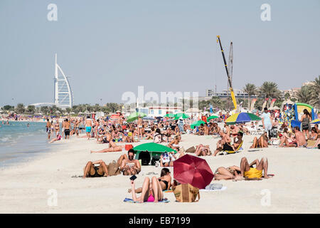 Busy public beach at Jumeirah Beach Resort (JBR) at Marina District in Dubai United Arab Emirates Stock Photo