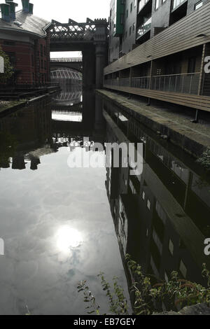 Portrait from Potato Wharf sun and hotel reflecting in arm of Castlefield Canal Basin, to Great Northern Viaduct, Manchester, UK Stock Photo