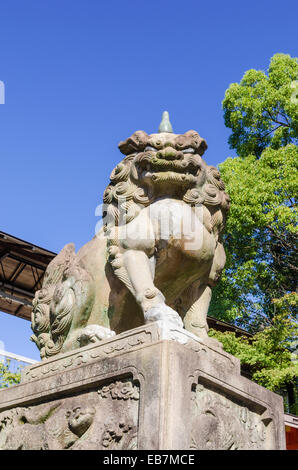 A stone lion-dog guardian, one of a pair guarding the entrance to the Yasaka Shrine, Kyoto, Kansai, Japan Stock Photo