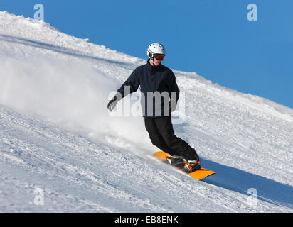 Snowboarder downhill Stock Photo