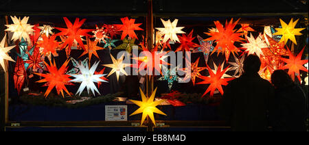 Munich, Germany. 27th Nov, 2014. Lamps in the shape of stars hang down a booth at the Christmas Market in Munich, Germany, 27 November 2014. Photo: Andreas Gebert/dpa/Alamy Live News Stock Photo