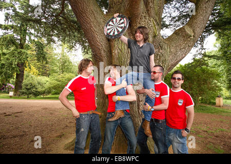 Embrace (English band) playing darts outside in Kemble , Gloucestershire, England, United Kingdom. Stock Photo