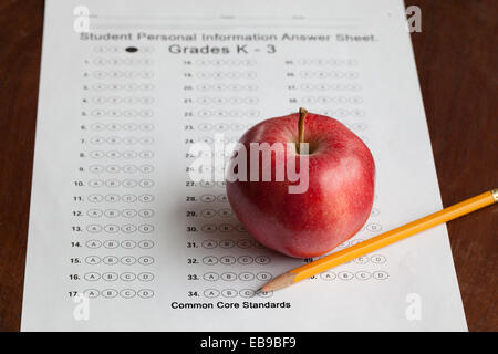 A bubble test answer sheet with an apple and pencil on it that are used for common core standards. Stock Photo