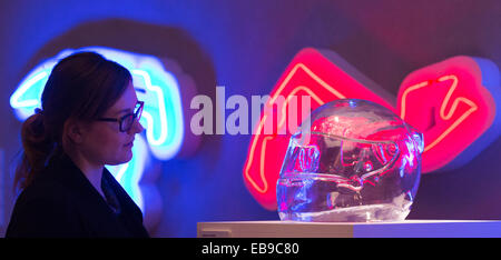 Glass helmet of a Formula 1 driver with neon signs of Formula 1 circuits. Angela Palmer's solo exhibition 'Adrenalin', Fine Art Stock Photo