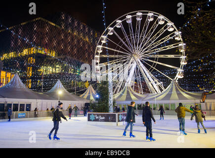 People enjoying Birmingham's Big Wheel and ice skating rink infront of the library, Centenary Square, England, UK, November 27th 2014. Stock Photo