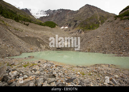 A meltwater lake at the snout of the rapidly retreating Bionnassay glacier coming off the Mont Blanc range. It has retreated over 200 metres in the last twenty years. Stock Photo