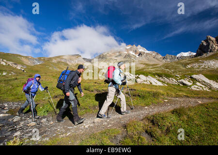 Walkers on the Tour de Mont Blanc in the Vallon de la Lex Blanche in Italy, below Mont Blanc. Stock Photo