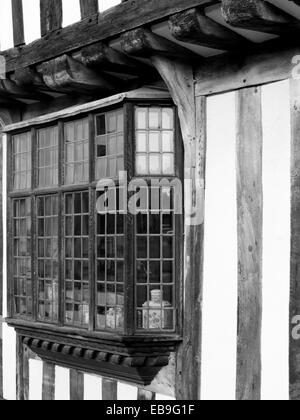Medieval leaded bay windowsfrom an English half-timbered black and white Tudor house in Lavenham, Suffolk England Stock Photo