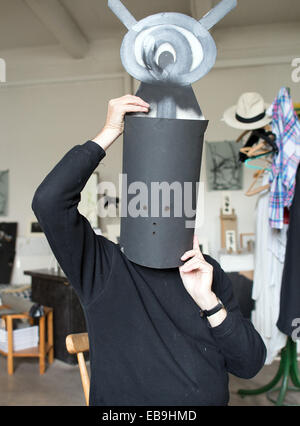 Duesseldorf, Germany. 21st Nov, 2014. Artist Harald Naegeli stands with his magic hat over his head in his studio in Duesseldorf, Germany, 21 November 2014. The artist, who is famous for his graffiti in Zurich in the 1970's, will turn 75 on 04 December 2014. Photo: FEDERICO GAMBARINI/dpa/Alamy Live News Stock Photo