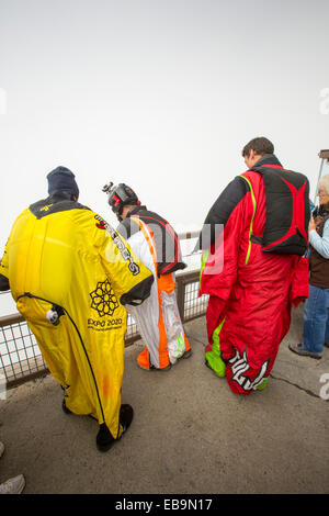 Base jumpers wearing wing suites prepare to jump from the Aiguille Du midi above Chamonix, France. Stock Photo