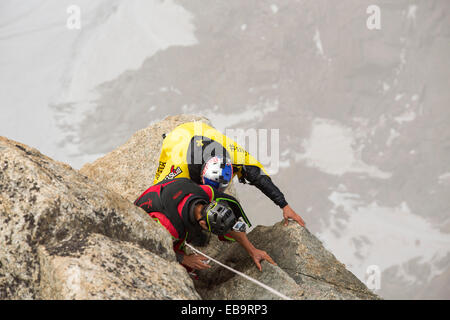 Base jumpers wearing wing suites prepare to jump from the Aiguille Du midi above Chamonix, France. Stock Photo