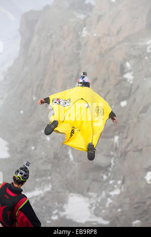 Base jumpers wearing wing suites jump from the Aiguille Du midi above Chamonix, France. Stock Photo