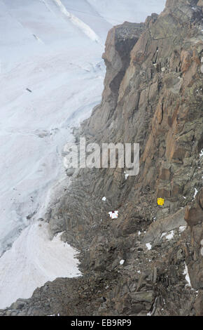 Base jumpers wearing wing suites jump from the Aiguille Du midi above Chamonix, France. Stock Photo