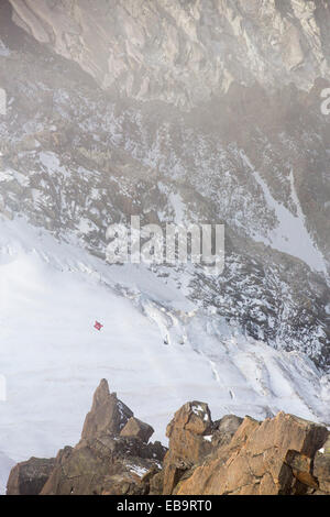 Base jumpers wearing wing suites jump from the Aiguille Du midi above Chamonix, France. Stock Photo