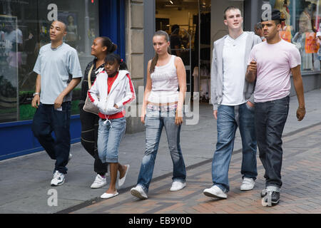 Multiracial group of teenagers walking down a street together, Stock Photo