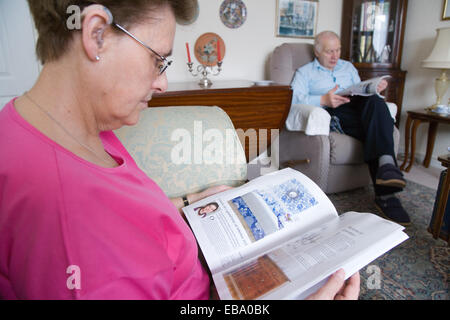 Older couple relaxing at home reading, Stock Photo