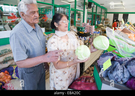 Older couple out shopping for vegetables, Stock Photo