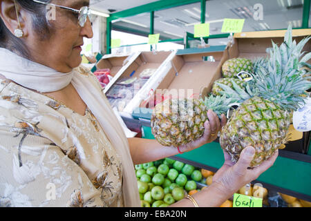 Older woman out shopping for fruit, Stock Photo
