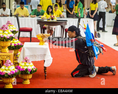 Bangkok, Bangkok, Thailand. 28th Nov, 2014. A man who said he walked all the way to Bangkok from Nakhon Ratchisma (Korat), about 235 kilometers, makes an offering after praying for Bhumibol Adulyadej, the King of Thailand, in the lobby of Siriraj Hospital. The King was born on December 5, 1927, in Cambridge, Massachusetts. The family was in the United States because his father, Prince Mahidol, was studying Public Health at Harvard University. He has reigned since 1946 and is the world's currently reigning longest serving monarch and the longest serving monarch in Thai history. Bhumibol, who Stock Photo