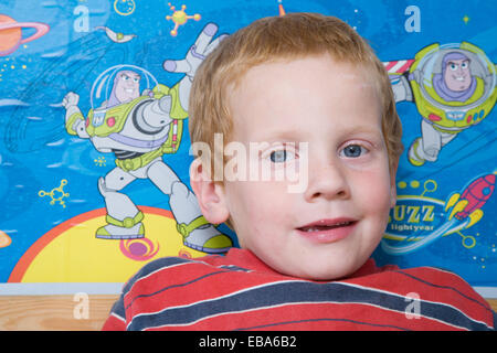 Little boy sitting in his bedroom, Stock Photo