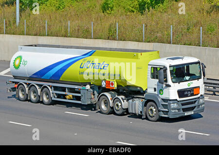 BP fuel delivery tanker trailer & MAN hgv lorry truck driving on M25 motorway & displaying Hazchem Hazardous Chemicals Dangerous Goods sign England UK Stock Photo