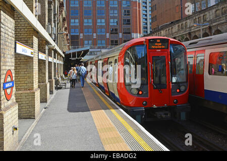 Summer train passengers leaving London Underground Metropolitan Line public transport trains at Barbican station platform City of London England UK Stock Photo