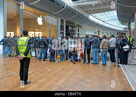 Security staff supervising crowd control outside Apple store in Westfield shopping centre Stratford Newham East London England UK Stock Photo