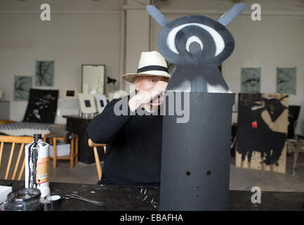 Duesseldorf, Germany. 21st Nov, 2014. Artist Harald Naegli looks at one of his works at his atelier in Duesseldorf, Germany, 21 November 2014. The artist, who became known as the 'Sprayer of Zurich' in the 1970s will celebrate his 75th bithday on 04 December 2014. Photo: Federico Gambarini/dpa/Alamy Live News Stock Photo