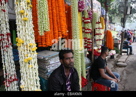 November 2014. Flower vendor at his stall in the flower market in Dhaka Bangladesh Stock Photo