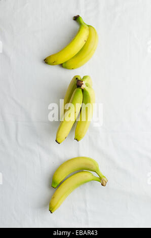 Multiple bananas over white cloth, above view Stock Photo