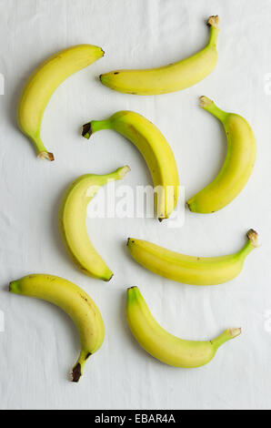 Multiple bananas over white cloth, above view Stock Photo