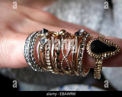 Selection of costume jewellery rings on woman's finger Stock Photo