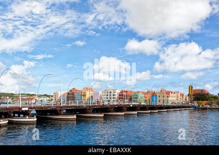 Queen Emma bridge, pontoon bridge at Willemstad, Curaçao. Colorful houses of Handelskade waterfront in background. Stock Photo