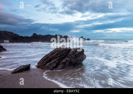 Waves crashing over rocks at Whitsand Bay in Cornwall Stock Photo