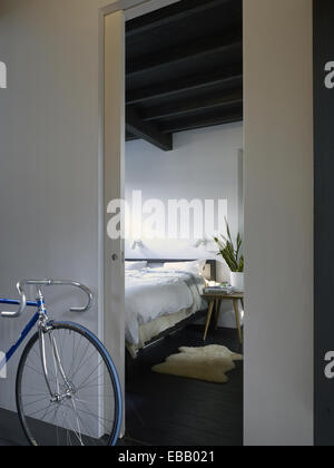 View of a bedroom from a passage way and bicycle in a japanese apartment, Tokyo Japan Stock Photo