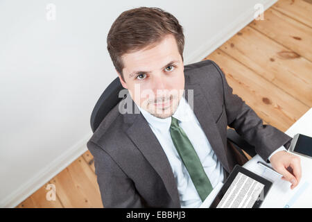 businessman in office and tablet on desk Stock Photo