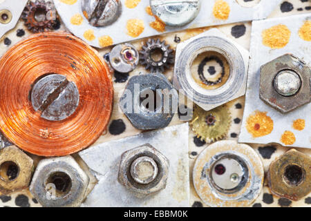 abstract background from screw nuts glued to board close up Stock Photo