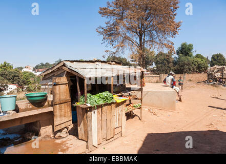 Wooden stall selling vegetables on a dusty roadside in a suburb of Antananarivo, or Tana, capital city of Madagascar Stock Photo