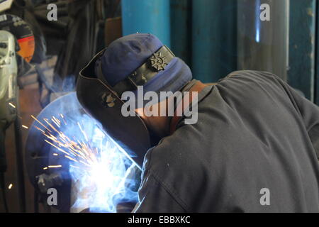 Industrial welder welding on steel in factory Stock Photo